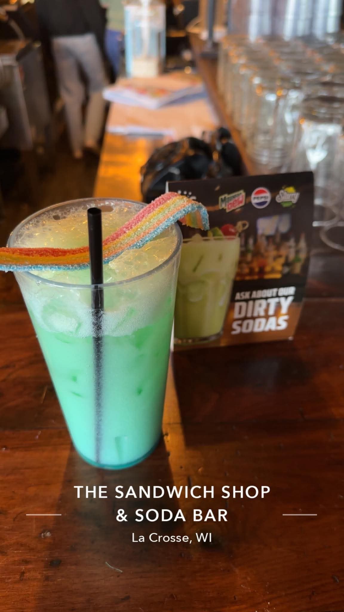 Green dirty soda with rainbow candy rim